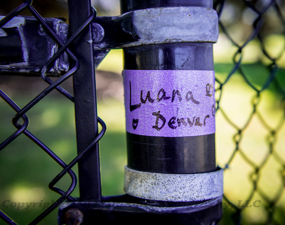 Name Remains Taped to Fence Post